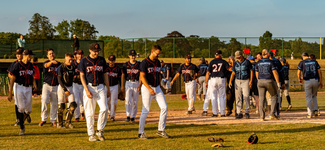 Baseball players gather on diamond at end of game